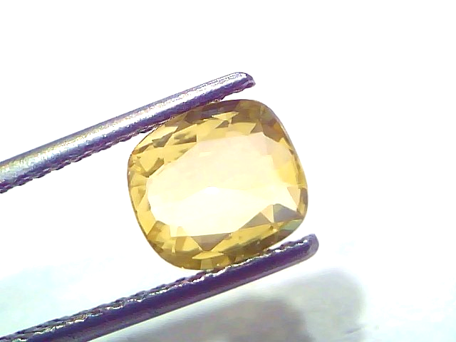 1.98 Ct Certified Unheated Natural Ceylon Yellow Sapphire Pukhraj displayed in tweezers, showcasing its brilliant cut and yel