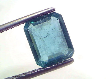 2.67 Carat Certified Natural Zambian Emerald, untreated, in emerald cut, held by tweezers against a white background.