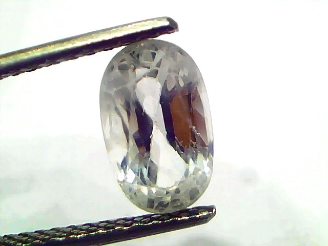 2.95 Ct Gii Certified Unheated Untreated Natural Ceylon White Sapphire held by tweezers, showcasing its clarity and brillianc