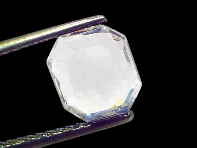 2.85 Ct Gii Certified Unheated Untreated Natural Ceylon White Sapphire, octagonal cut, held by tweezers against a light backg