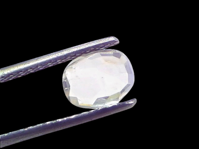 1.97 Ct Certified Unheated Untreated Natural Ceylon White Sapphire held by tweezers, showcasing its clarity and brilliance.