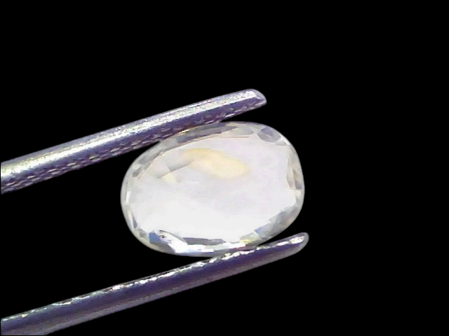 2.05 Ct Certified Unheated Untreated Natural Ceylon White Sapphire, oval-shaped, held by tweezers, showcasing clarity and bri