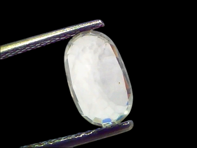 2.95 Ct Gii Certified Unheated Untreated Natural Ceylon White Sapphire, oval-cut gemstone held by tweezers, showcasing clarit