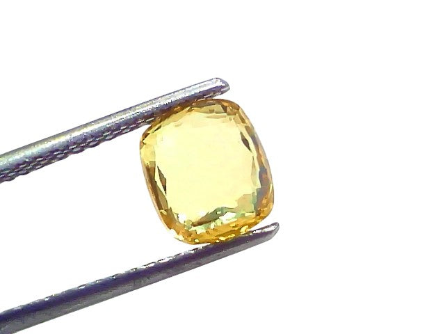 Natural Ceylon Yellow Sapphire, 3.05 ct, cushion cut, VVS clarity, held with tweezers against a white background.
