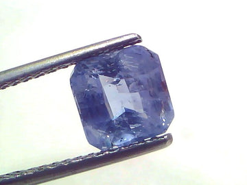 3.10 Ct Certified Unheated Untreated Natural Ceylon Blue Sapphire, displayed in tweezers, showcasing its vibrant blue color a