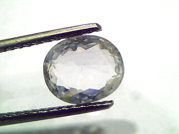 3.11 Ct Gii Certified Unheated Untreated Natural Ceylon White Sapphire, oval cut, held with tweezers against a light backgrou