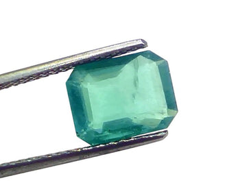 Natural Zambian Emerald by Venus Gems, 3.21 carats, untreated, octagonal cut, vibrant green color, held with tweezers.