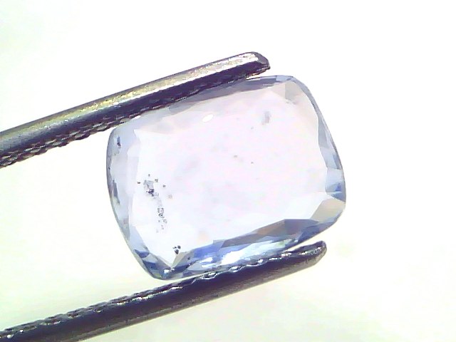 Ceylon Blue Sapphire gemstone, 3.50 Ct, unheated and untreated, displayed in tweezers against a white background.