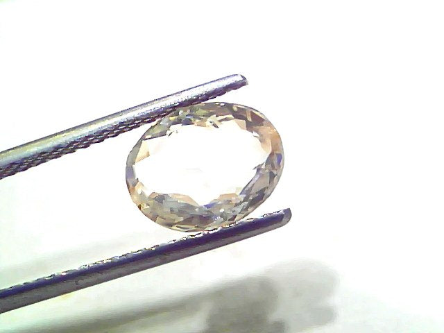 3.52 Ct Certified Unheated Untreated Natural Ceylon White Sapphire held by tweezers, showcasing its clarity and brilliance.