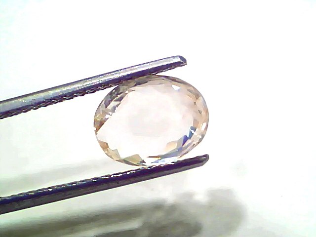 3.52 Ct Certified Unheated Untreated Natural Ceylon White Sapphire held by tweezers, showcasing its clarity and brilliance.