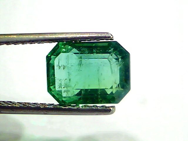 3.61 Carat Certified Natural Zambian Emerald, untreated, octagonal cut, displayed in tweezers against a white background.