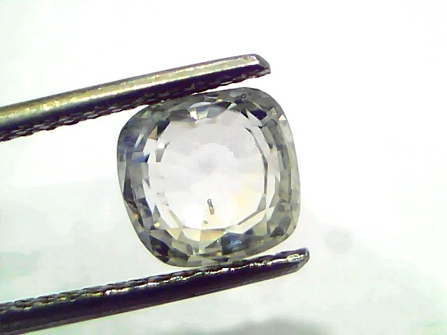 3.62 Ct Gii Certified Unheated Untreated Natural Ceylon White Sapphire, cushion cut, held by tweezers against a light backgro