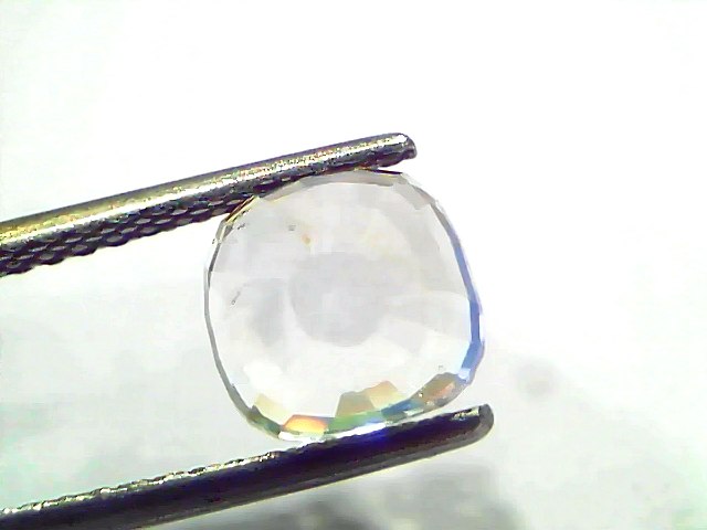 3.62 Ct Gii Certified Unheated Untreated Natural Ceylon White Sapphire, cushion cut, held by tweezers against a light backgro