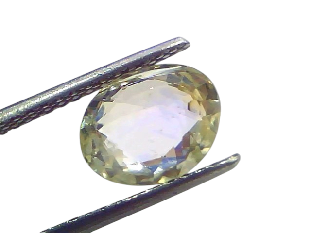 Oval-cut 3.65 Ct certified unheated natural Ceylon yellow-blue sapphire held by tweezers, showcasing its clarity and brillian