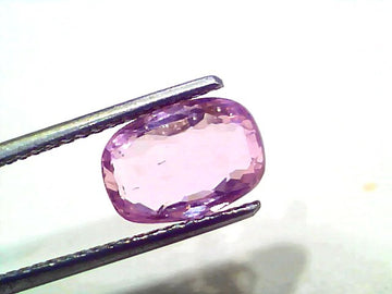 3.87 Ct Certified Unheated Untreated Natural Ceylon Pink Sapphire, oval cut, held by tweezers, showcasing its pink hue.