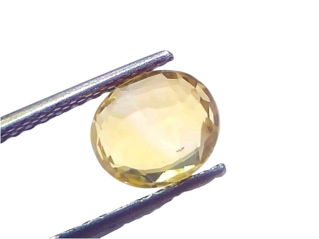 3.12 carat IGI certified yellow sapphire Pukhraj stone, unheated, displayed in tweezers against a light background.