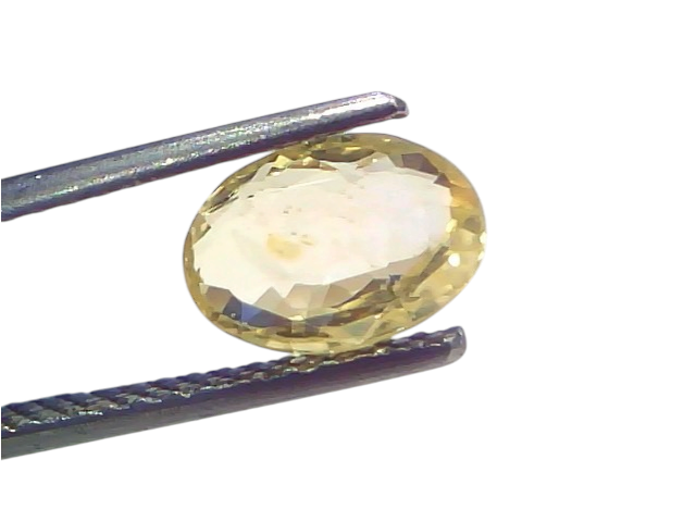 3.14 Ct IGI Certified Unheated Natural Ceylon Yellow Sapphire Pukhraj held by tweezers, showcasing its oval cut and yellow hu