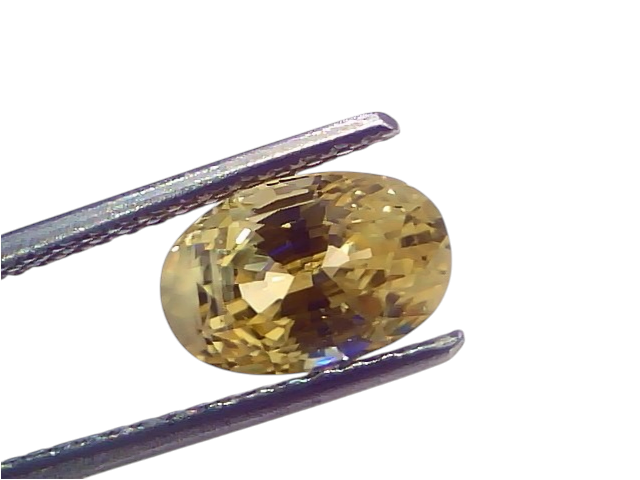 3.60 Ct IGI Certified Unheated Natural Ceylon Yellow Sapphire Pukhraj, oval cut, held with tweezers, showcasing its brillianc
