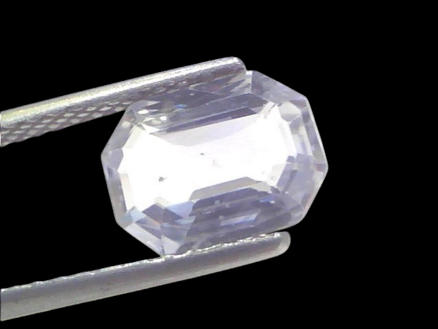 3.29 Ct Gii Certified Unheated Untreated Natural Ceylon White Sapphire, octagonal cut, held by tweezers against a white backg