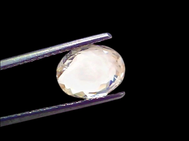 3.52 Ct Certified Unheated Untreated Natural Ceylon White Sapphire held by tweezers, showcasing its clarity and brilliance.