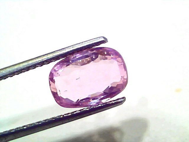3.87 Ct Certified Unheated Untreated Natural Ceylon Pink Sapphire, oval cut, held by tweezers, showcasing its pink hue.