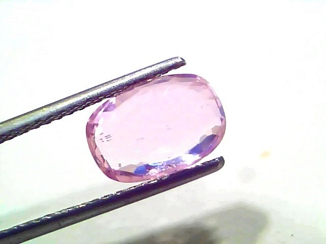 3.87 Ct Certified Unheated Untreated Natural Ceylon Pink Sapphire, oval cut, held by tweezers, showcasing its pink hue.