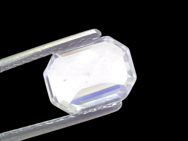3.29 Ct Gii Certified Unheated Untreated Natural Ceylon White Sapphire, octagonal cut, held by tweezers against a white backg