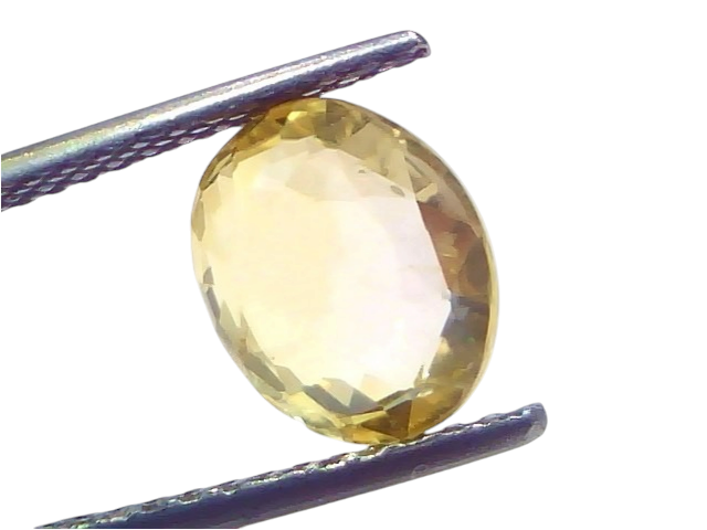 3.53 carat IGI certified unheated natural Ceylon yellow sapphire in an oval cut, held by tweezers against a light background.