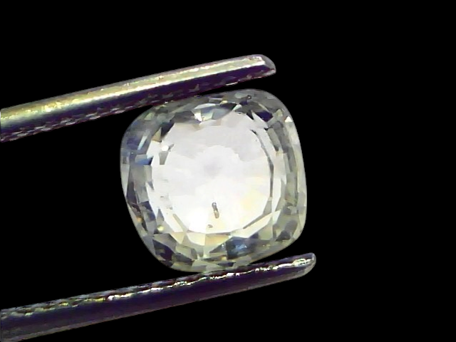 3.62 Ct Gii Certified Unheated Untreated Natural Ceylon White Sapphire, cushion cut, held by tweezers against a light backgro