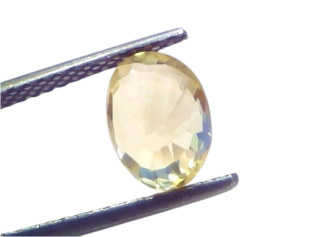 3.05 carat IGI certified unheated natural Ceylon yellow sapphire in an oval cut, held by tweezers against a light background.