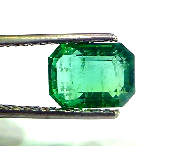 3.61 Carat Certified Natural Zambian Emerald, untreated, octagonal cut, displayed in tweezers against a white background.