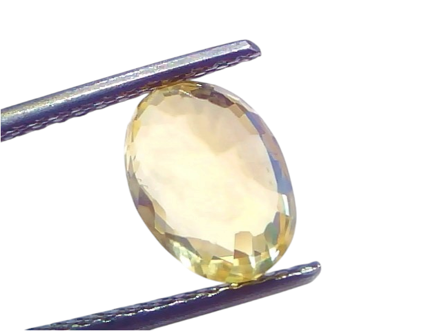 IGI Certified 3.79 Carat Yellow Sapphire Pukhraj, unheated, oval-cut stone held by tweezers against a light background.