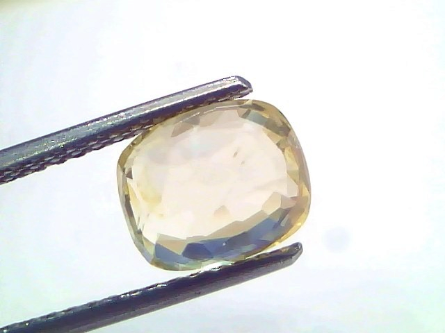 3.27 Ct IGI Certified Unheated Natural Ceylon Yellow Sapphire Pukhraj displayed in tweezers, showcasing its brilliant cut and