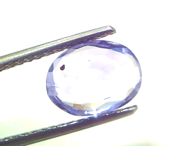 Oval-shaped natural Ceylon blue sapphire, 3.15 Ct, unheated and untreated, displayed with tweezers.