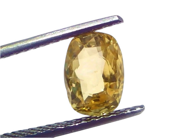 A 3.08 carat IGI certified yellow sapphire (Pukhraj) held by tweezers, showcasing its unheated, radiant cut and vibrant yello