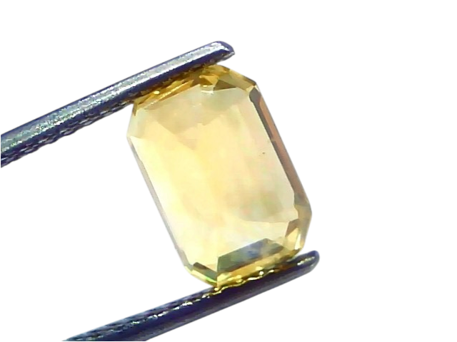 4.06 Ct IGI Certified Unheated Natural Ceylon Yellow Sapphire Pukhraj AAA, emerald cut, displayed on a tweezer against a whit