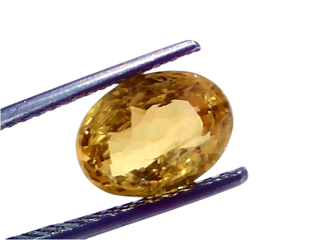 4.18 Ct IGI Certified Unheated Natural Ceylon Yellow Sapphire Pukhraj, oval-shaped, held by tweezers against a white backgrou