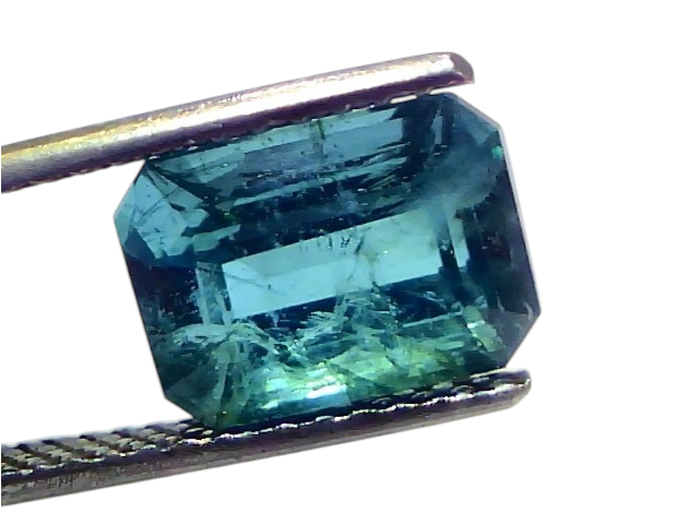 Natural Zambian emerald, 4.44 carats, octagonal cut, showcasing deep green hues and clarity, held by tweezers.
