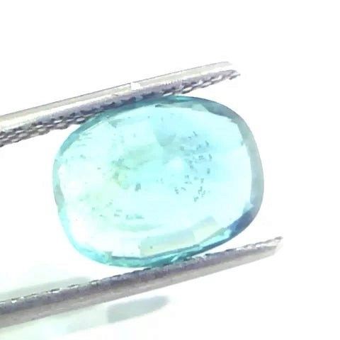 4.28 Ct Untreated Natural IGI Certified Zambian Emerald Gemstone AA, displayed in tweezers with a light blue hue.