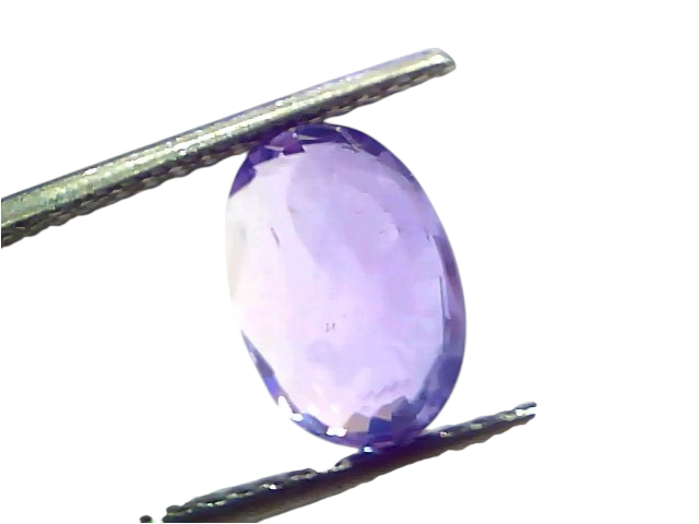 Oval-shaped 4.11 carat unheated natural Ceylon purple sapphire, held with tweezers, showcasing its vibrant color and clarity.