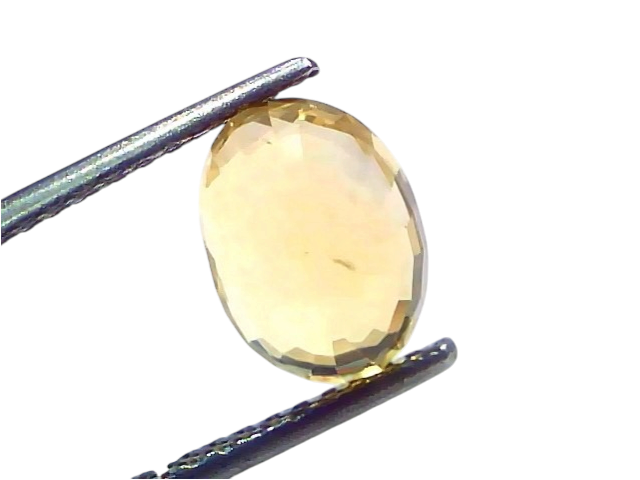 Oval-shaped 4.55 Ct IGI Certified Unheated Natural Ceylon Yellow Sapphire Pukhraj, displayed with tweezers against a light ba