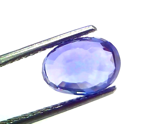 4.09 carat IGI certified unheated natural Ceylon blue sapphire held by tweezers, showcasing its vibrant blue color and brilli