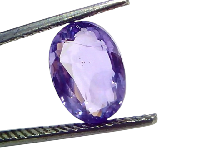 Oval-shaped 4.11 carat unheated natural Ceylon purple sapphire, held with tweezers, showcasing its vibrant color and clarity.