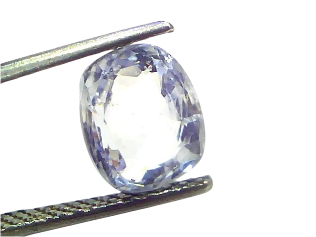 Venus Gems 4.09 carat natural cushion-cut white sapphire gemstone held in tweezers, showing clear VVS clarity.