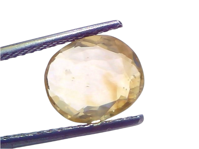 4.07 carat IGI certified unheated natural Ceylon yellow sapphire, oval cut, displayed in tweezers against a light background.