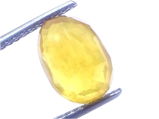 5.68 carat certified natural yellow sapphire Pukhraj stone, oval cut, held with tweezers against a bright background.