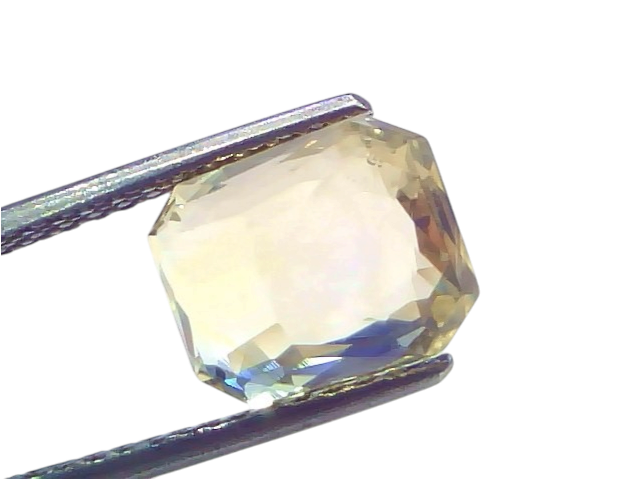 5.16 Ct IGI Certified Unheated Natural Ceylon Yellow Sapphire Pukhraj, octagonal cut, held with tweezers against a white back