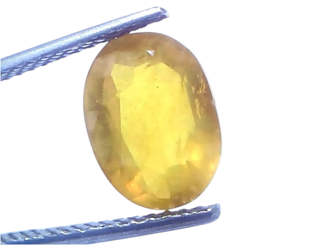 5.68 carat certified natural yellow sapphire Pukhraj stone, oval cut, held with tweezers against a bright background.