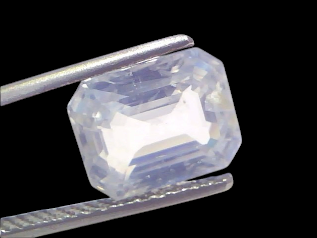 5.70 Ct Gii Certified Unheated Untreated Natural Ceylon White Sapphire, displayed in tweezers, showcasing its clarity and cut