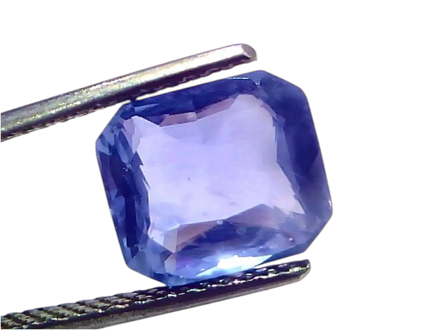 5.54 carat IGI certified unheated natural Ceylon blue sapphire, octagonal cut, held by tweezers against a white background.